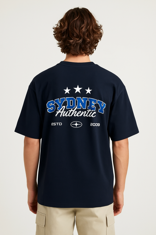 Person wearing a navy blue t-shirt with 'Sydney Authentic' text on the back, standing against a white background.